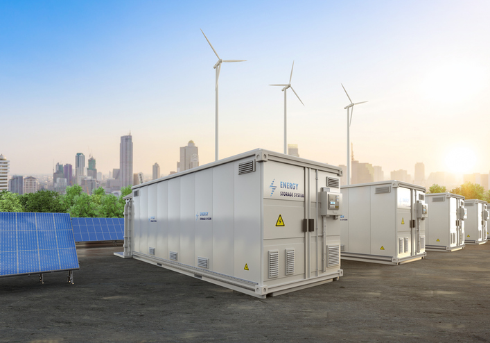 Energy storage units in front of wind turbines, made from custom sheet metal components and assemblies